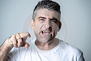 Portrait of a mature 40s to 50s white angry and upset man looking furious and aggressive human emotions facial expressions and