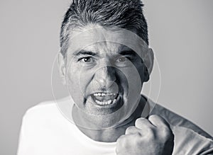 Portrait of a mature 40s to 50s white angry and upset man looking furious and aggressive human emotions facial expressions and
