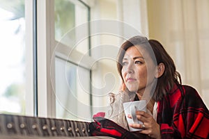 Portrait of a mature Asian woman in deep thought.