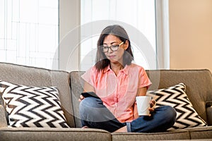 Portrait of a mature Asian woman texting on the phone.