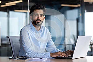 Portrait of mature businessman boss, man serious thinking looking at camera, businessman at workplace working inside