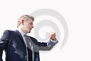 Portrait of mature businessman checking time on his watch while waiting in the airport