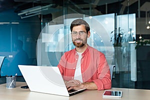 Portrait of mature businessman freelancer startup, bearded man smiling and looking at camera, business owner working