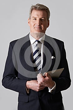 Portrait Of Mature Businessman Holding Digital Tablet