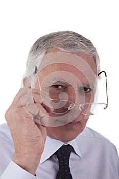 Portrait of a mature businessman,putting the glas