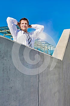 Portrait of mature businessman relaxing on rooftop