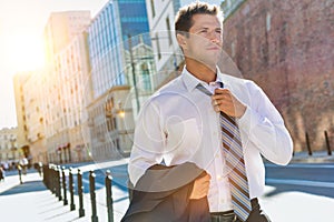 Portrait of mature businessman walking on pavement after work