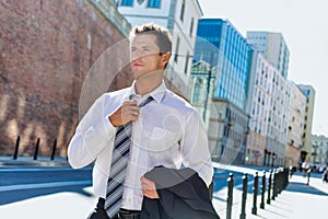Portrait of mature businessman walking on pavement after work