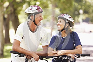 Portrait Of Mature Couple On Cycle Ride Through Park