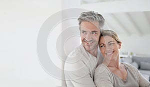 Portrait of mature couple embracing at home