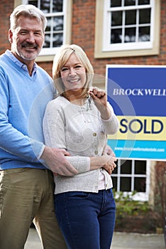 Portrait Of Mature Couple With Keys To New Home