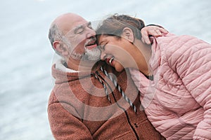 portrait of a mature couple laughing and hugging
