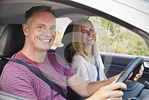 Portrait Of Mature Couple Sitting In Car On Road Trip