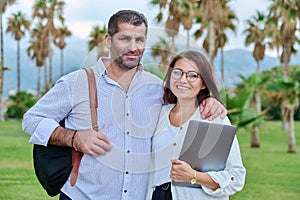 Portrait of mature couple, smiling man and woman looking at camera