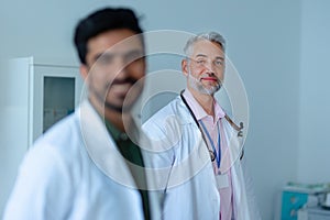 Portrait of mature doctor at hospital room.