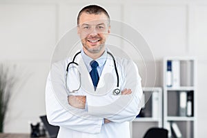 Portrait of mature doctor smiling and looking at camera