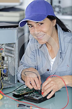 Portrait mature female technician working in office