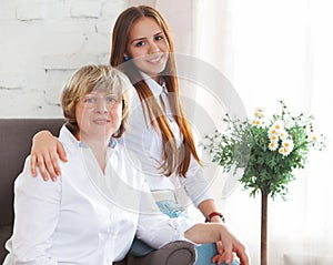 Portrait of a mature grandmother and teen granddaughter and teen