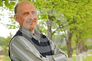 Portrait of mature man with crossed hands