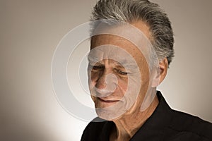 Portrait of a mature man with graying hair wearing a black shirt