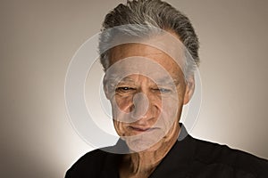 Portrait of a mature man with graying hair wearing a black shirt