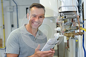 Portrait mature man holding instructions for gas boiler