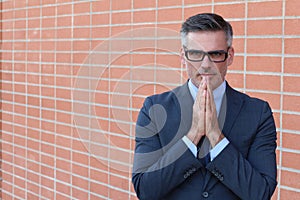 Portrait of mature man praying with copy space