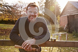 Portrait Of Mature Man Repairing Garden Fence