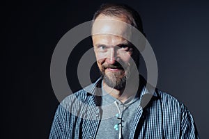 Portrait of a mature man smiling at camera with confusion