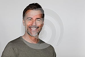 Portrait Of A Mature Man Smiling At The Camera. Isolated on white. Left side.