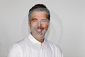 Portrait Of A Mature Man Smiling At The Camera. Isolated on white. Left side. Jacquet