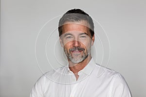 Portrait Of A Mature Man Smiling At The Camera. Isolated on white. Left side. Jacquet