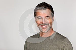 Portrait Of A Mature Man Smiling At The Camera. Right side of the picture.