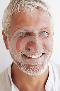 Portrait Of Mature Man Standing Against Wall