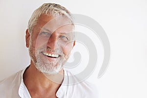 Portrait Of Mature Man Standing Against Wall