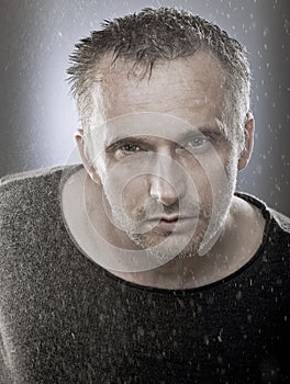 Portrait of mature man under the spindrift, studio shoot.