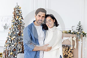 Portrait of mature married couple man and woman exchange Christmas time smiling and looking at camera, celebrating new