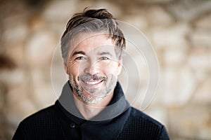 Portrait Of A Mature Men Smiling At The Camera At Home