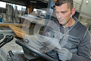 Portrait mature metal worker standing in workshop