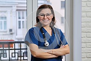 Portrait of mature nurse woman in blue uniform with stethoscope