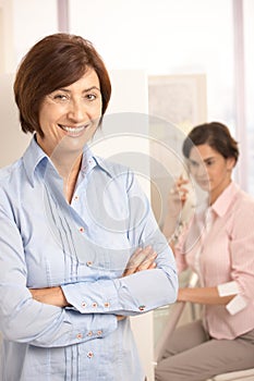 Portrait of mature office worker smiling at camera