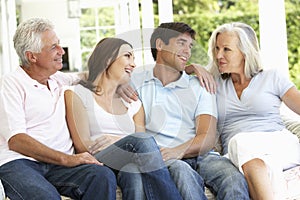 Portrait Of Mature Parents Relaxing With Grown Up Children photo