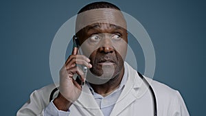 Portrait mature serious man talking on mobile phone focused puzzled confused professional doctor pediatrician therapist