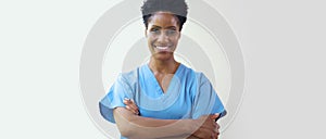 Portrait Of Mature Smiling Female Doctor Wearing Scrubs In Hospital With Copy Space