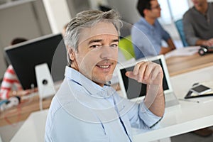 Portrait of mature teacher in class