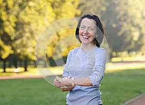 Portrait of mature woman cheking the pulse after jog in the park