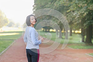 Portrait of mature woman before or after jog in the park photo