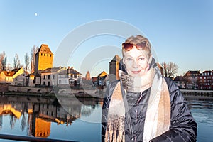 Portrait of mature woman at the medieval bridge Ponts Couverts and barrage Vauban