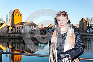 Portrait of mature woman at the medieval bridge Ponts Couverts and barrage Vauban