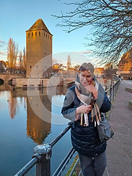 Portrait of mature woman at the medieval bridge Ponts Couverts and barrage Vauban